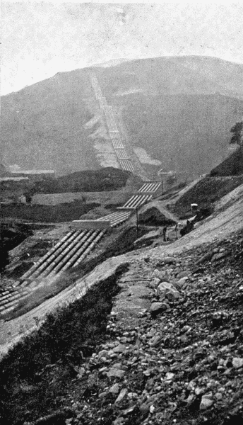 By permission of the British Aluminium Co

A Striking Feature of Modern Aluminium Works

For the production of aluminium water power is required. Water is stored at a high
level and is then brought down to the factory in pipes. The illustration shows the pipe
track recently laid down for this purpose at Kinlochleven in Argyleshire. The six pipes,
each of which is thirty-nine inches in diameter, run down the hillsides for one mile and
a quarter