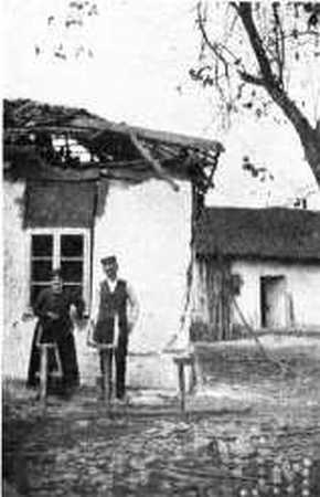 HOUSE NEAR THE ARSENAL DAMAGED BY BOMBS.